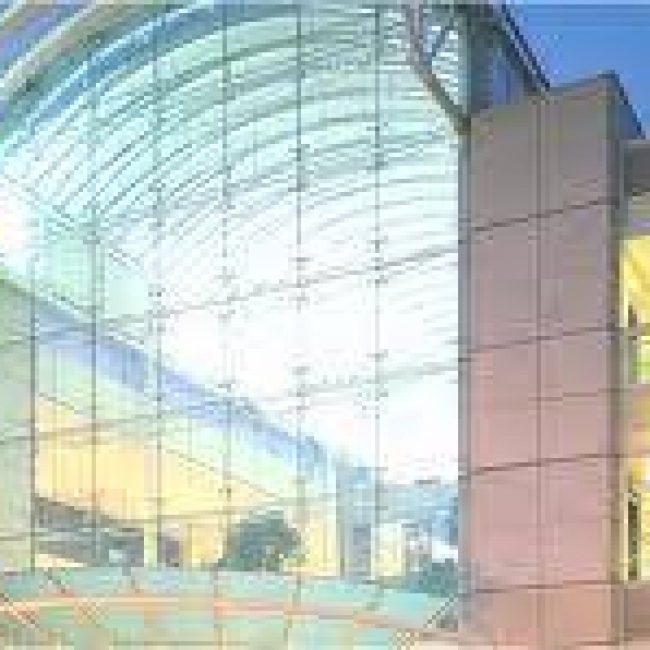 An exterior shot of the glass frontage of a large building