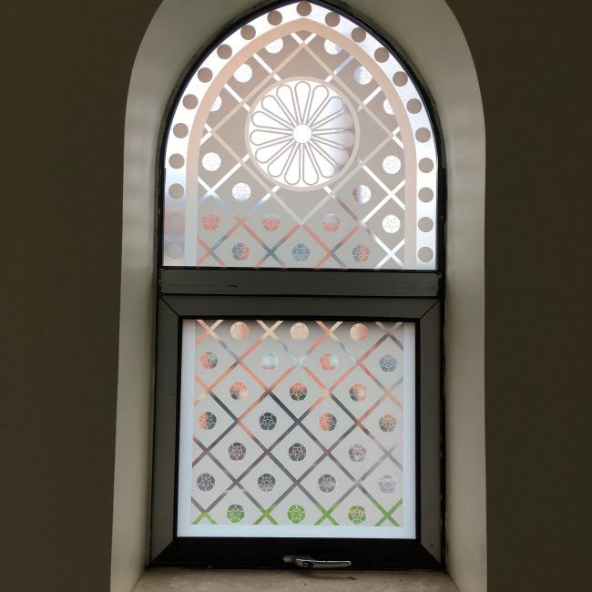 Small window arch with decorative window film installed